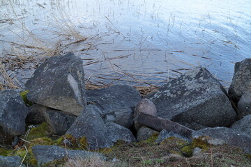 Rock, boulders and stones at the lake shore. 