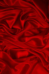 Rich and luxury red silk fabric texture background.