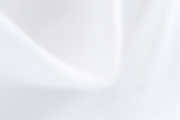 White abstract background of blurred fabric texture. Close-up light white satin fabric texture for luxury, smooth fabric curve, wavy, minimal fashion, and textiles. Blurry white cloth wave background.