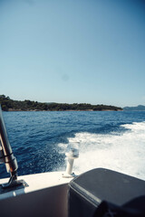 Fototapeta premium Sea waves behind the back of speedboat outside Dubrovnik, Croatia in summer