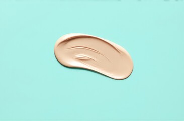 Fototapeta premium Oil or cream or scrub macro texture smears. Skincare Texture Swatch. Natural gel smears or drops placed on pastel green background. Face Cream. Cleanser Serum Treatment. Pastel colors.