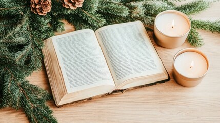 Fototapeta premium An open book rests on a wooden table, accompanied by a soft fabric blanket, evergreen branch, and warm candlelight, creating a tranquil reading atmosphere