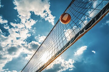 Volleyball is flying over the net on a sunny day. The sun is shining through the net, creating a beautiful lens flare