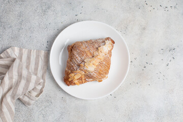 Almond Croissant pastry on a light table. Bright mood style. Perfect for recipe, article, catalogue. 
