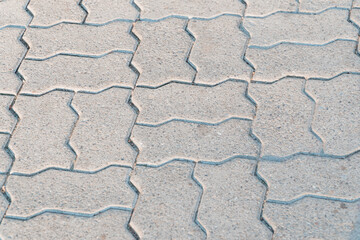 Obraz premium Elegant Texture of Interlocking Concrete Pavers in Soft Morning Light