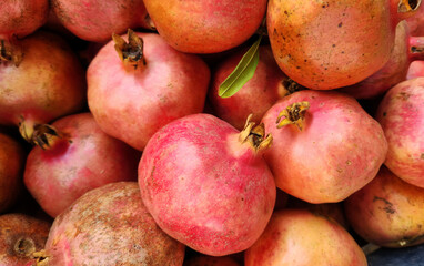 Pomegranates sold in a market shelf in autumn