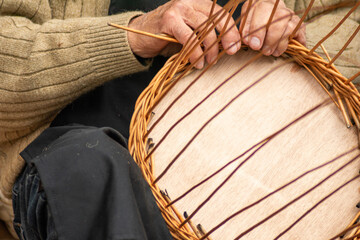 a craftsman weaving traditional wicker baskets at an ethnologic festival in Galicia