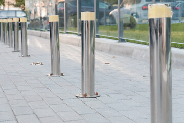 Urban Stainless Steel Bollards on Paved Pathway in Modern Landscape Design