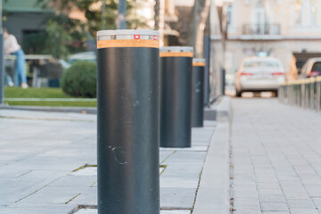 Elegant Urban Barrier Stanchions with Illuminated Safety Markers in a Modern Streetscape