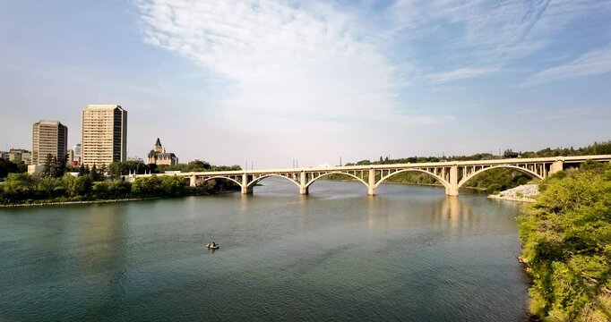 The iconic Broadway Bridge spans the Saskatchewan River in downtown Saskatoon, connecting the city with scenic views of the water and skyline