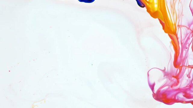 Liquid multi-colored paint on a white background