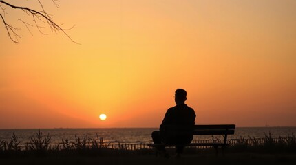 Obraz premium A tranquil sunset view by the lakeside with a solitary figure reflecting on life in the fading light