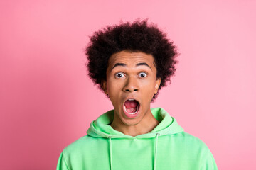 Photo of nice young man open mouth wear green hoodie isolared on pink color background