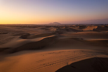 Immense and Dramatic Dune Landscape with Various Buggies Riding by Huacachina in Ica, Peru at Sunset