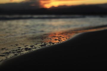 Sunset at sea. Balearic Sea, Salou, Spain. Beach, sea, small waves. Evening landscape on the coast....