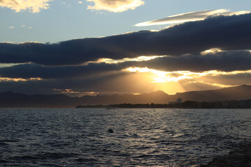 Sunset at sea. Balearic Sea, Salou, Spain. Beach, sea, small waves. Evening landscape on the coast. Vacation at sea