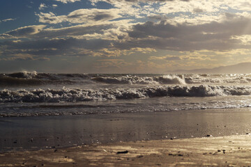 Sea view from the shore. Horizon on the sea. Balearic Sea, Salou, Spain. View of large waves on the sea from a low angle. Landscape. Stormy weather