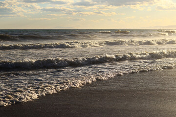 Sea view from the shore. Horizon on the sea. Balearic Sea, Salou, Spain. View of large waves on the sea from a low angle. Landscape. Stormy weather