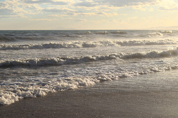 Sea view from the shore. Horizon on the sea. Balearic Sea, Salou, Spain. View of large waves on the sea from a low angle. Landscape. Stormy weather