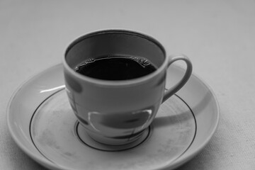 Instant coffee in a mug. A mug in a saucer on a yellow background. Top-down view