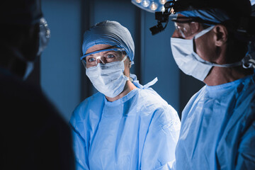 Medical team performing surgery in hospital operation theater.
