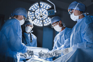 Surgeons operating at modern hospital