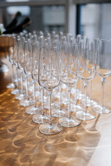 Elegant set of empty crystal wine glasses arranged for event or celebration in a bright setting