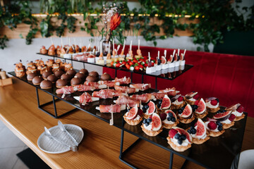 Delicious gourmet tartlets with fresh figs, raspberries, and blueberries served at catering event