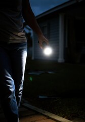 Fototapeta premium Exploring a dimly lit path with a flashlight at night