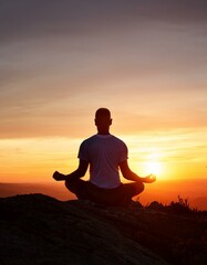 Man meditating at sunset