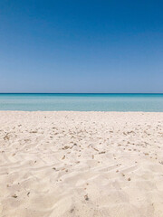 mediterranean white sand beach with turquoise clear sea on a summer day with blue sky