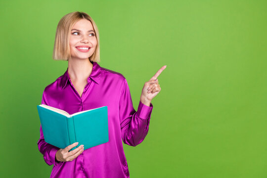 Photo of charming lovely girl wear stylish pink clothes hold book empty space isolated on green color background