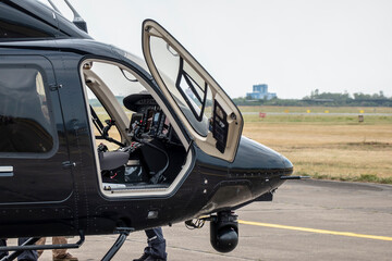 Helicopter used for police and military at the airport with side doors open