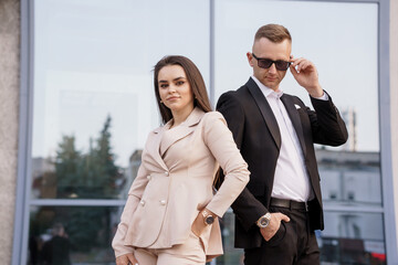 Elegant Business Duo Posing Confidently in Urban Setting