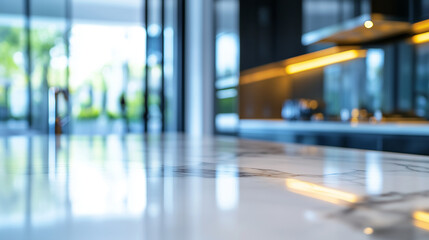 A modern kitchen with a luxurious marble bench in the foreground, its veins adding texture to the bright, clean design. The background is softly blurred, showing minimalist cabinet