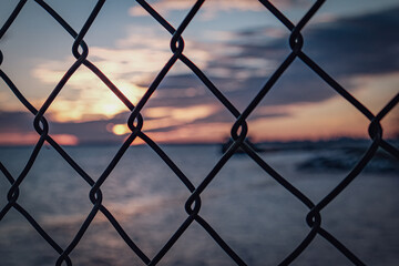 sunset behind fence