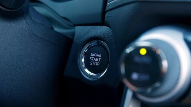 A woman confidently pressing the car's start button. This moment symbolizes freedom and driving style, making it ideal for automotive and technology advertising.