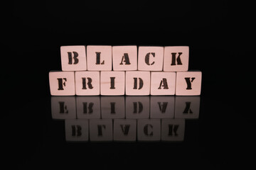 Black Friday sale concept with handmade wooden blocks and reflection.