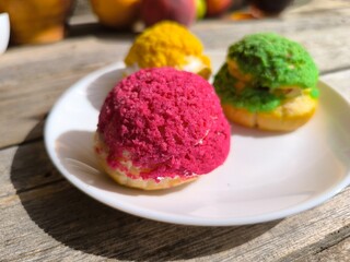 Three iced cakes on a plate. High-quality photos