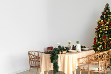 Dining table with Christmas setting and candles in kitchen