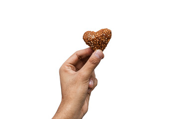 Heart-shaped kibbeh held by a hand, traditional Lebanese and Syrian dish.