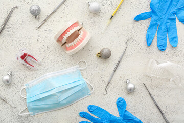 Dentist's tools with Christmas decor on grunge background