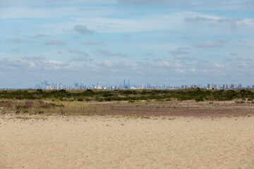 New York City is seen across the water from Sandy Hook, New Jersey. Brooklyn, including the famous Coney Island, can be seen in the front, with Manhattan Island behind.