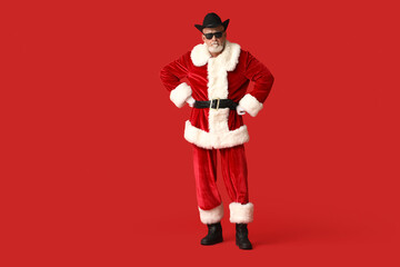 Santa Claus in stylish hat on red background