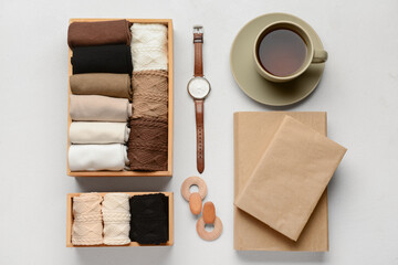 Basic color socks with wrist watch, accessories and cup of tea on white background