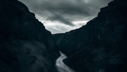 Obraz premium Narrow Winding Gorge Under Cloudy Sky