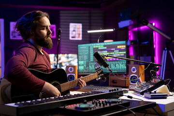 Creative musician singing a melody on microphone and playing guitar, signal processing technology...