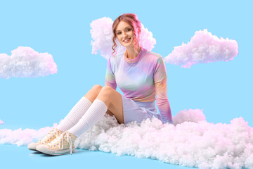 Young woman with white clouds sitting on blue background