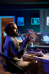 Scientist specializing in artificial intelligence putting EEG headset on to start uploading...
