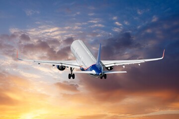 Airplane flying in blue sky with clouds, travel background